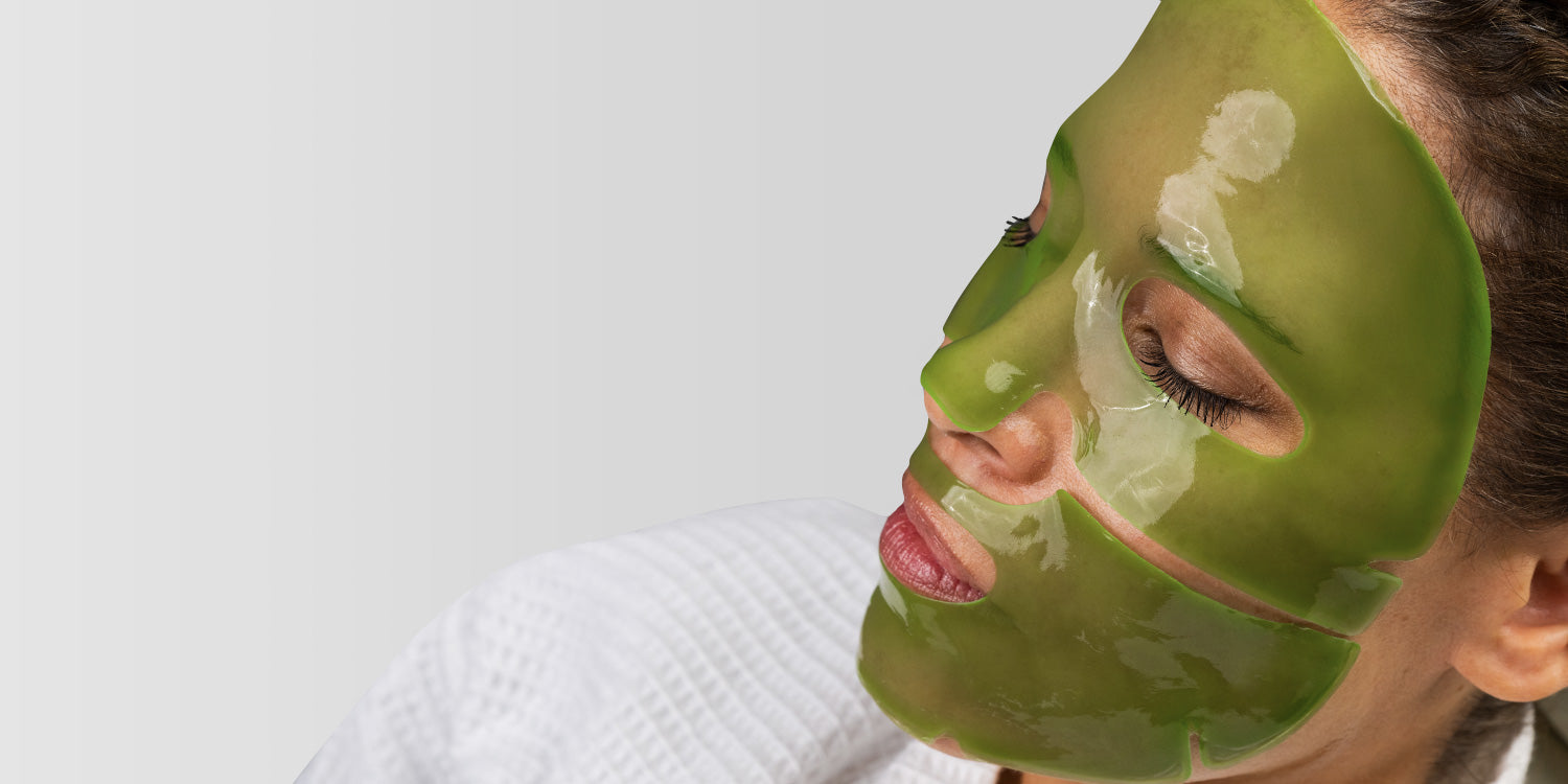 Person wearing a green facial mask on a white background