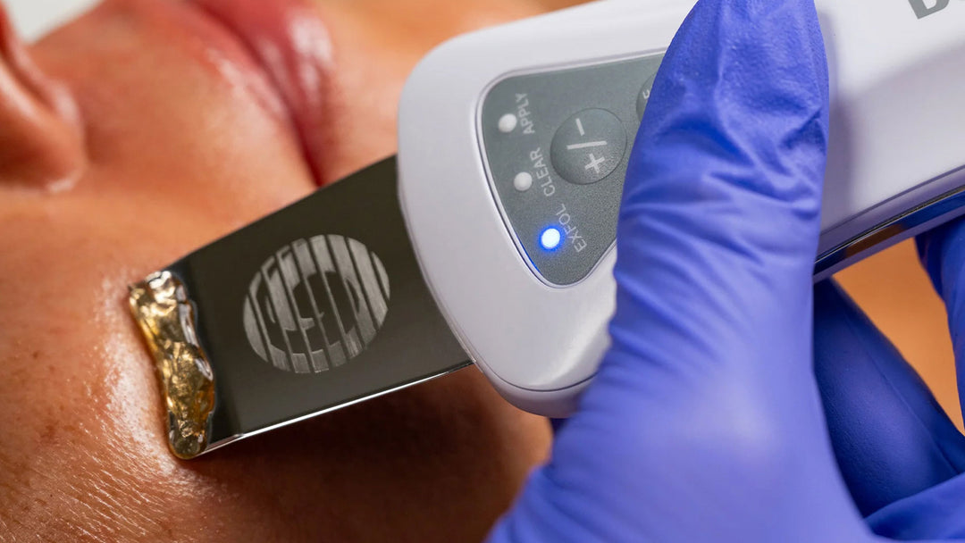 Close-up of a medical device being used on skin with a gloved hand