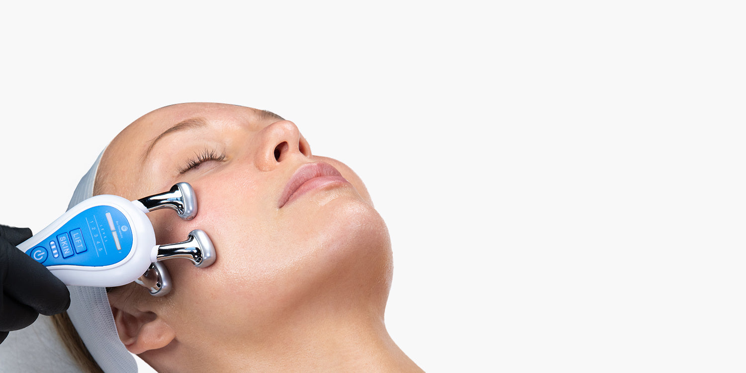 Woman receiving a facial treatment with a Bio-Therapeutic bt-sculpt device on a white background